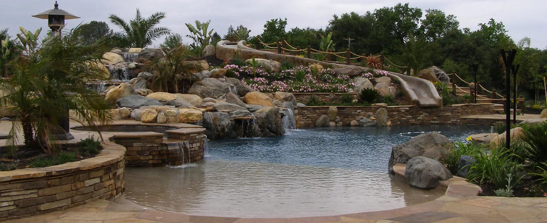 Custom pool remodel with stone waterfall feature